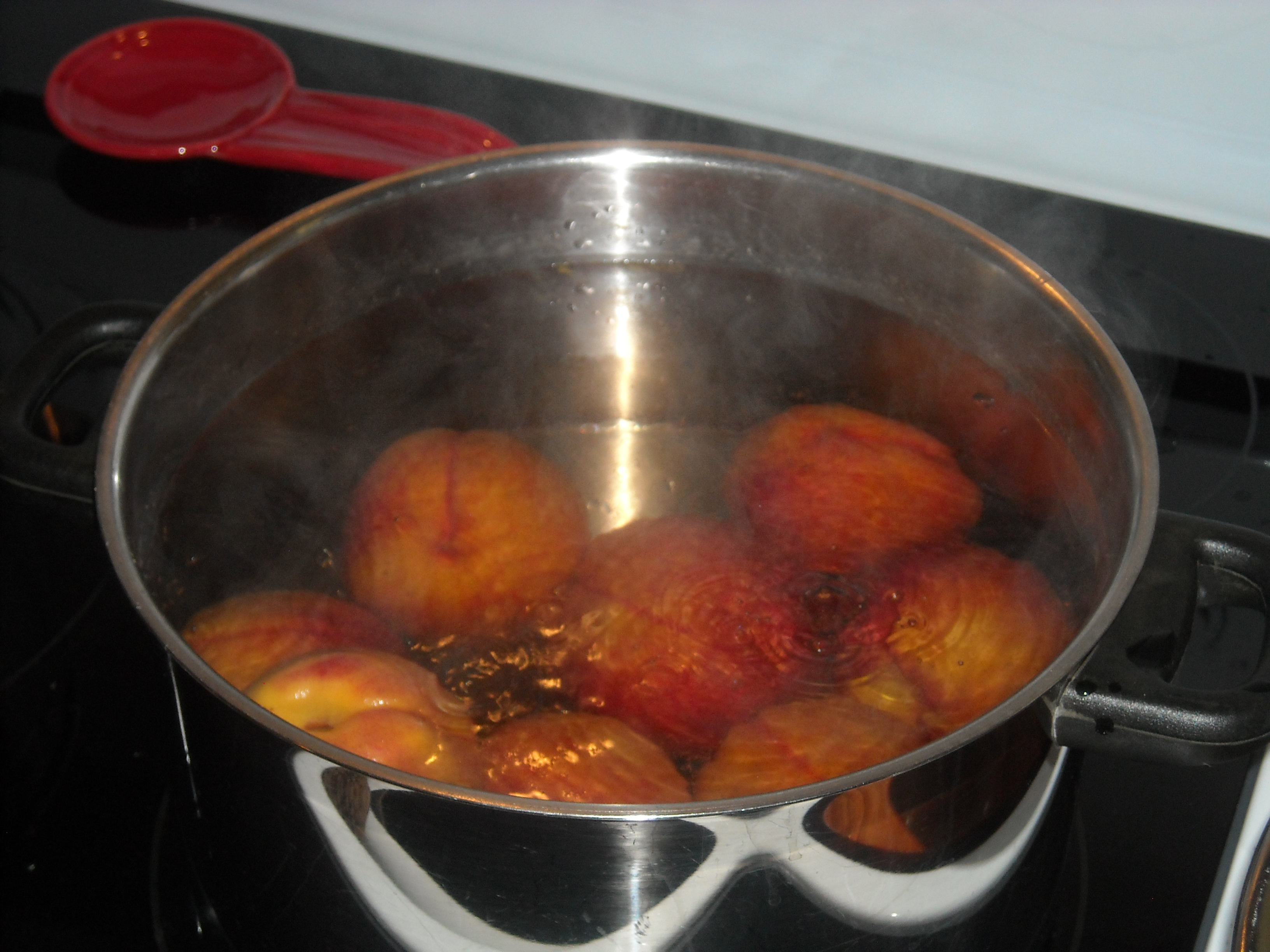 Peaches in boiling water.